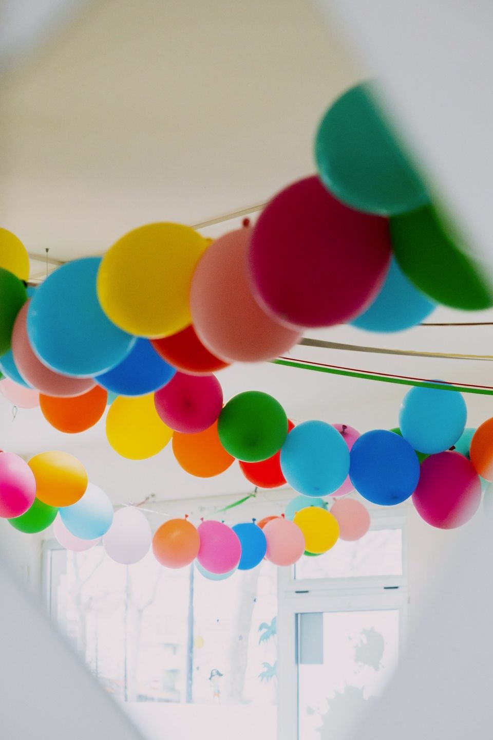 Festoni di palloncini colorati appesi al soffitto della sala